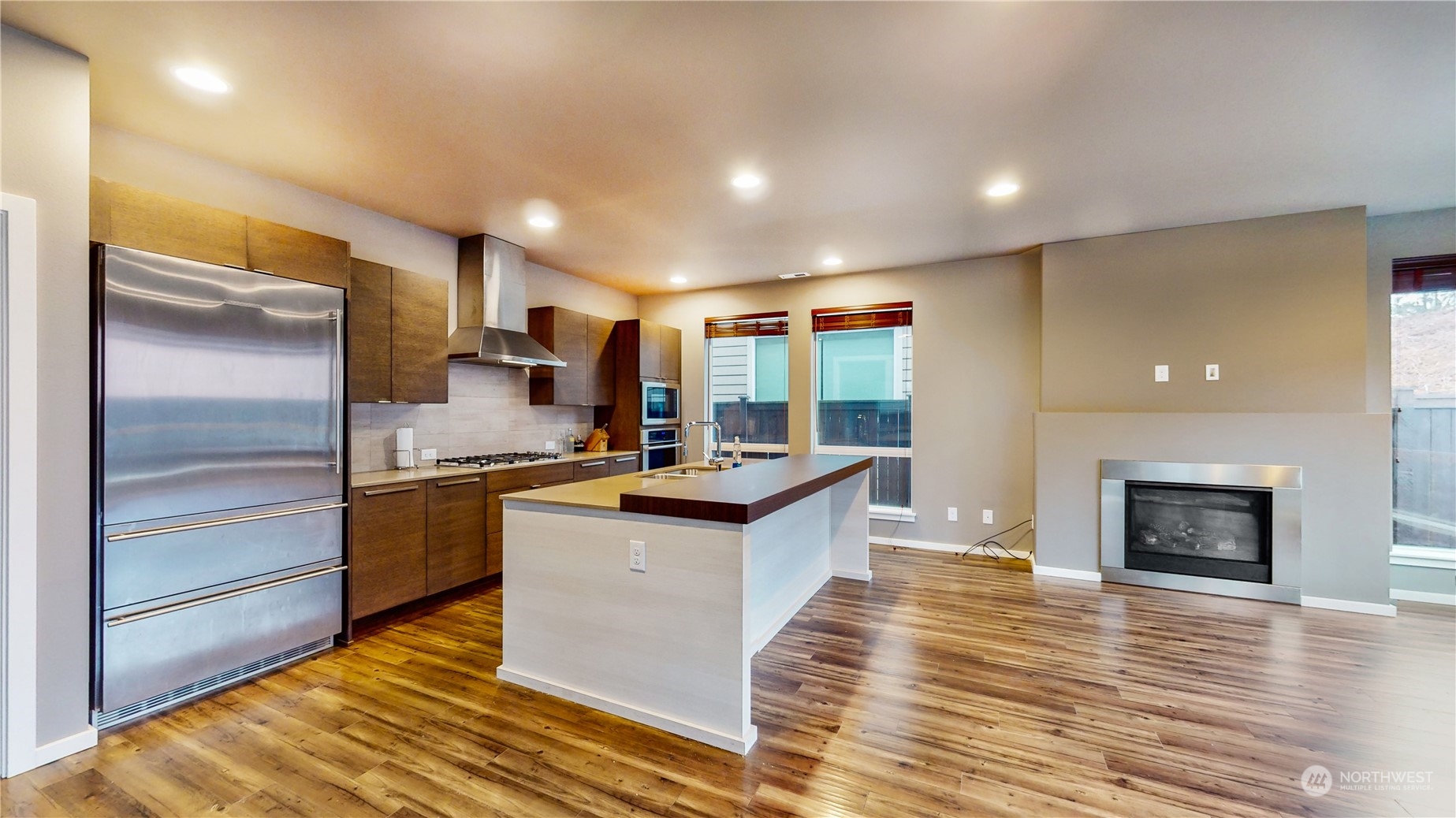 17009 42nd Drive Southeast Bothell, WA 98012 - Photo 7 of 26 a kitchen with stainless steel appliances granite countertop a refrigerator a stove and a wooden floors