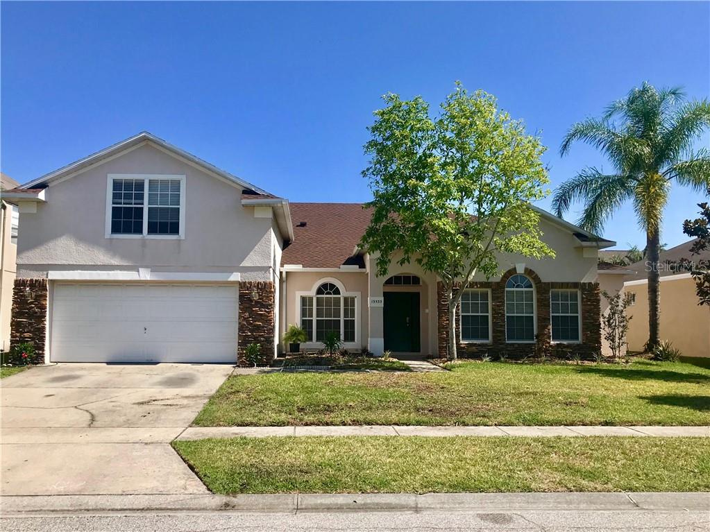 13533 Madison Dock Road Orlando, FL 32828 - Photo 1 of 1 a front view of a house with a yard