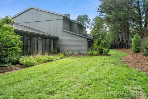 a house with green field in front of it