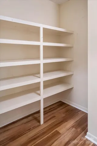 a view of walk in closet with empty racks