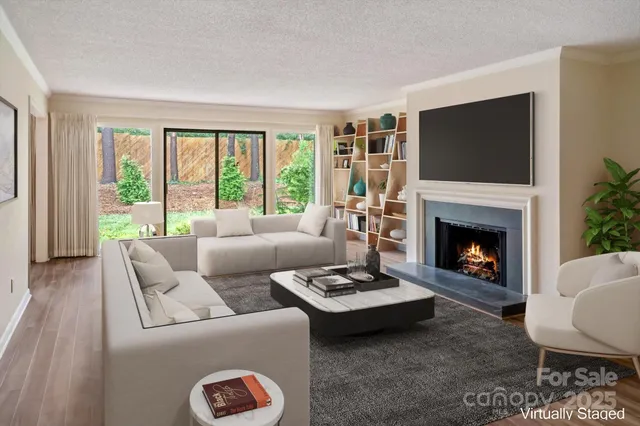 a living room with furniture a flat screen tv and a fireplace