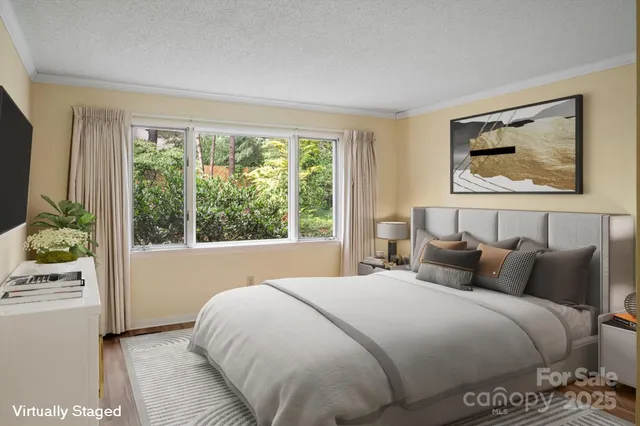 a bedroom with a bed and a painting on the wall