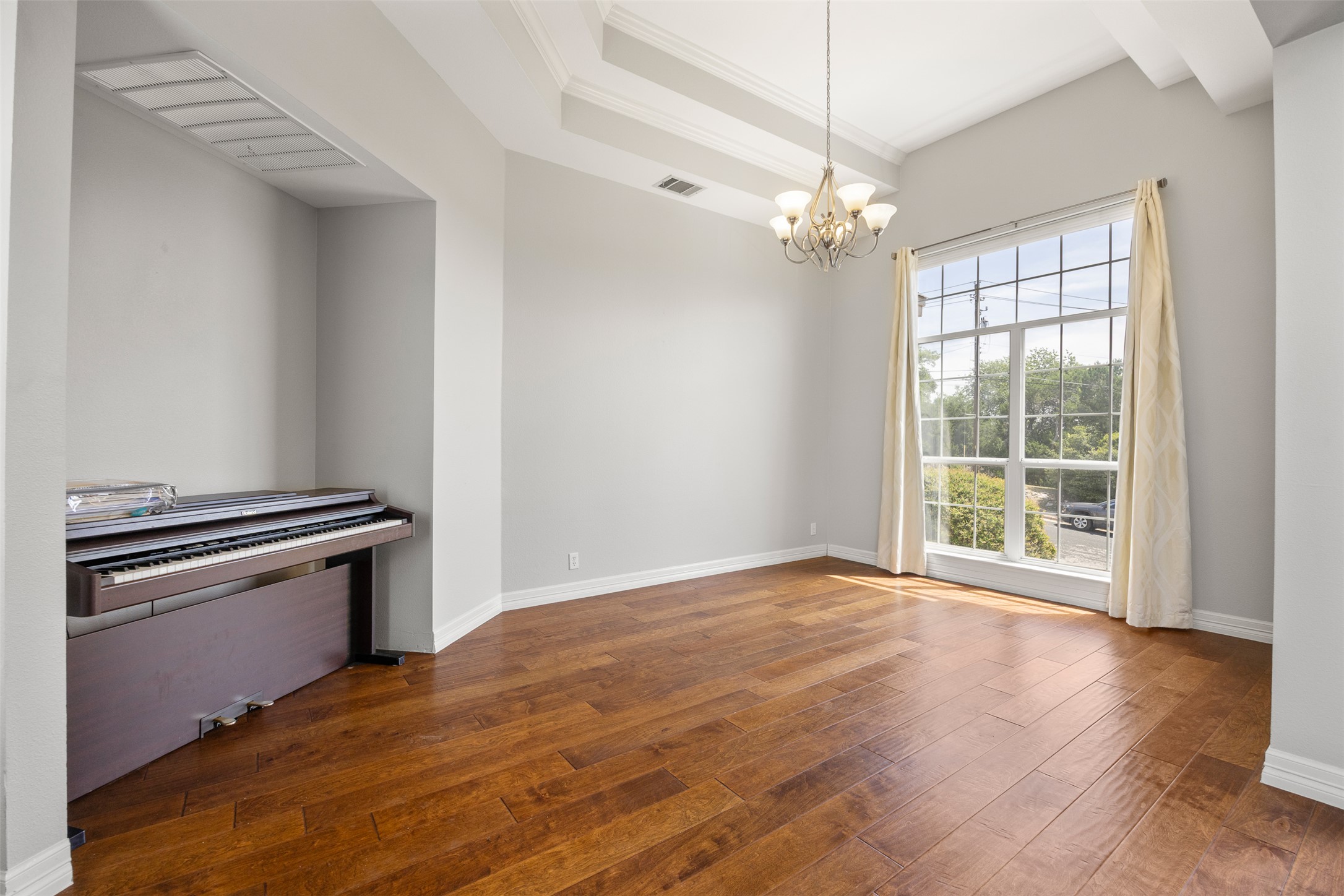 9300 Simmons Road Austin, TX 78759 - Photo 2 of 17 Natural light floods through the expansive window into this elegant room with high ceilings and hardwood flooring.
