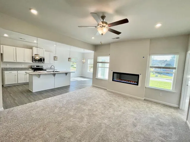a view of a kitchen with a sink cabinets and a fireplace