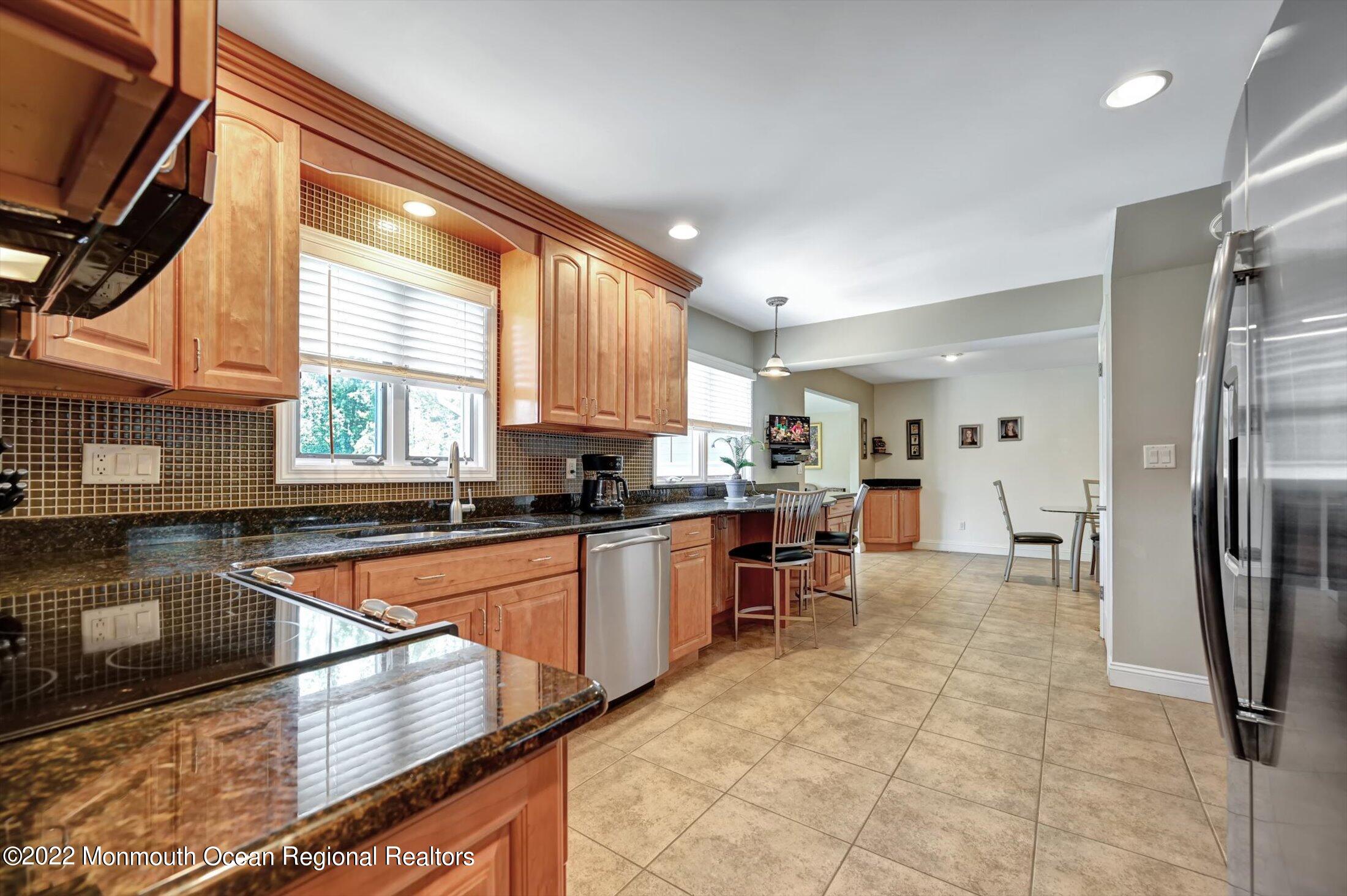 4 Sussex Road Morganville, NJ 07751 - Photo 14 of 55 a kitchen with stainless steel appliances granite countertop a refrigerator and a sink