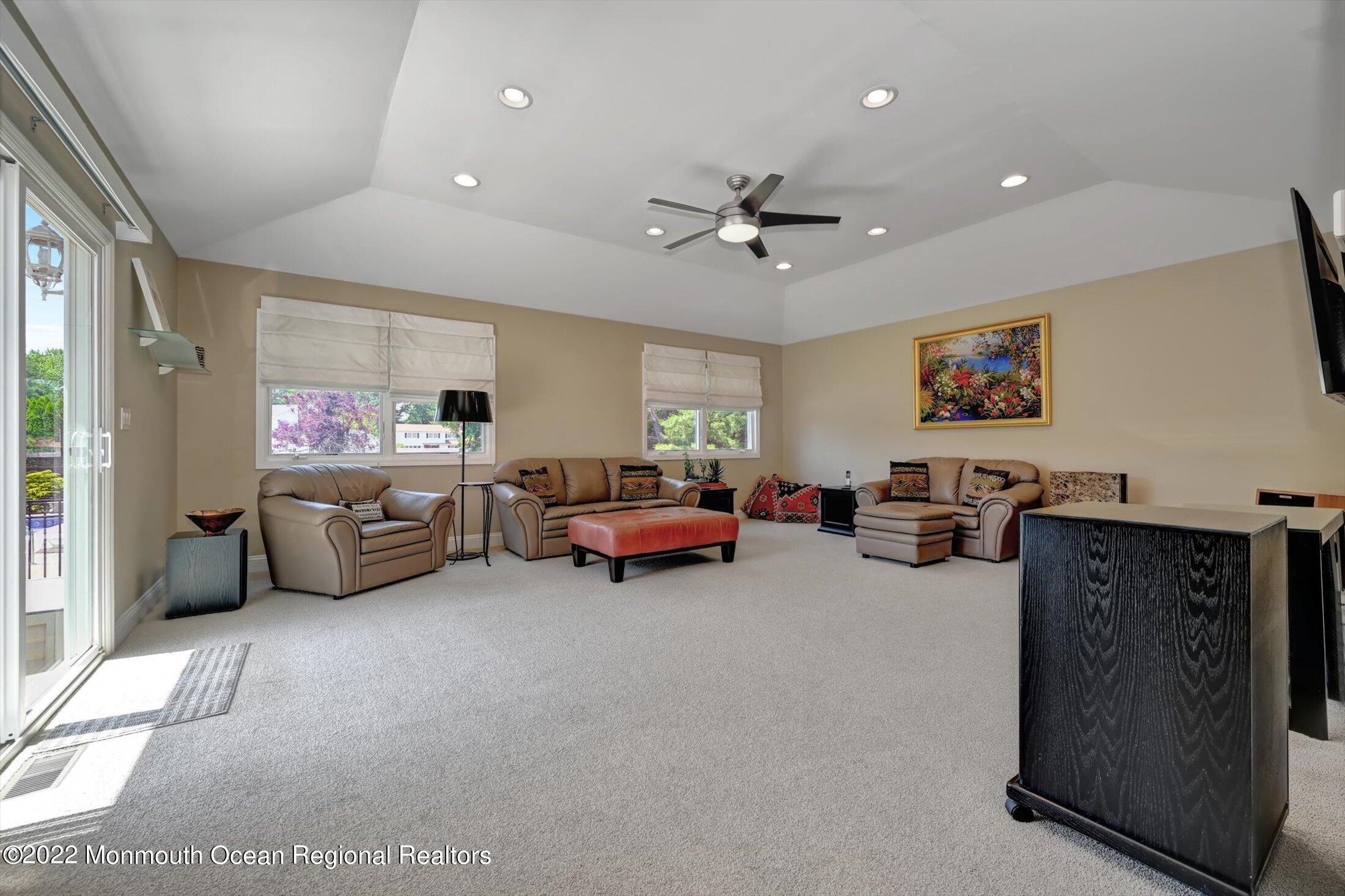 4 Sussex Road Morganville, NJ 07751 - Photo 18 of 55 a living room with furniture and a ceiling fan
