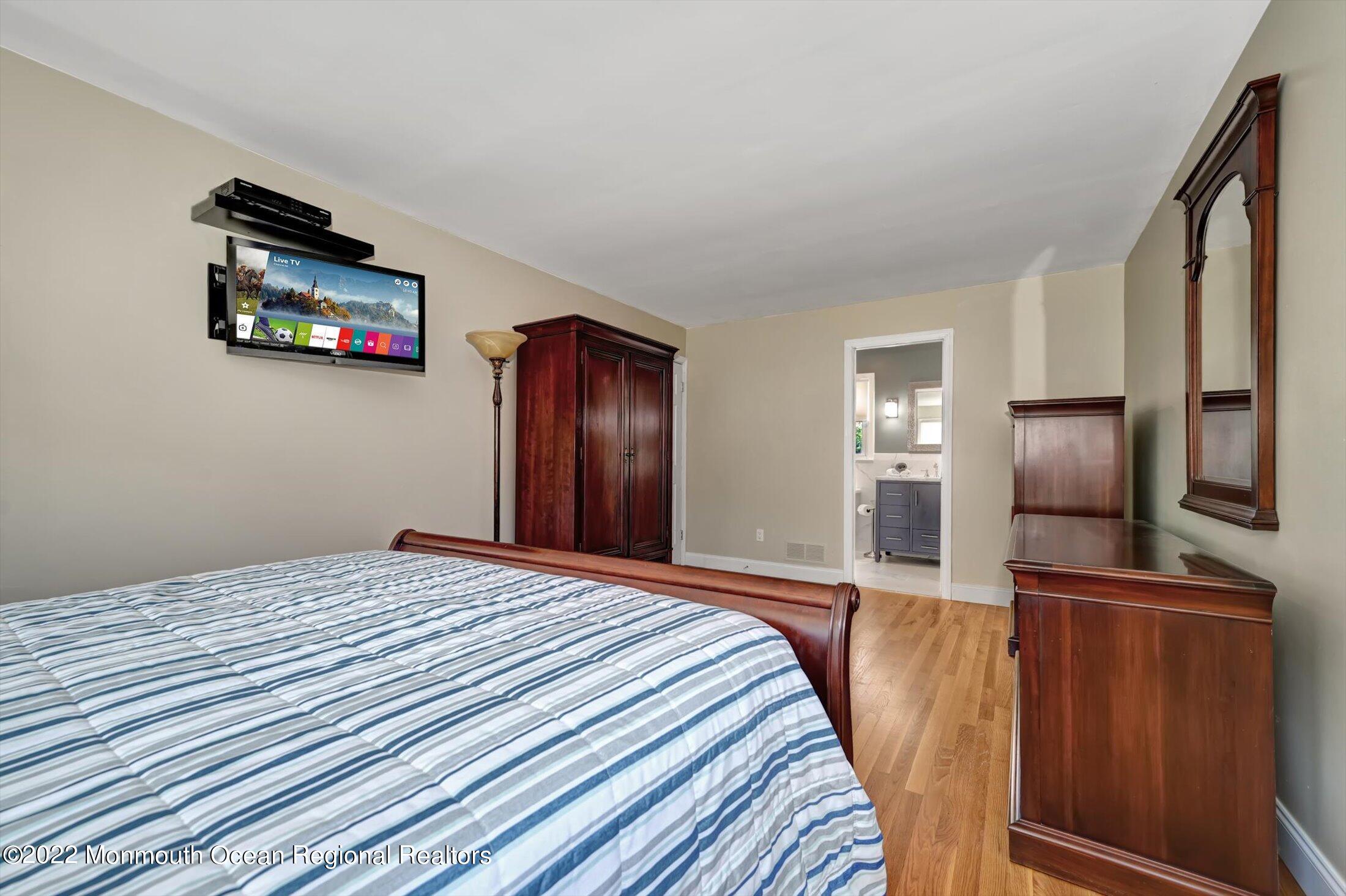 4 Sussex Road Morganville, NJ 07751 - Photo 23 of 55 a bedroom with a bed and a flat screen tv