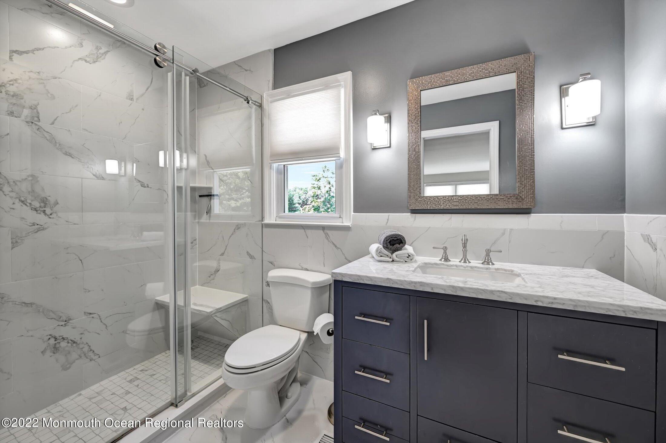 4 Sussex Road Morganville, NJ 07751 - Photo 24 of 55 a bathroom with a toilet sink vanity granite and shower