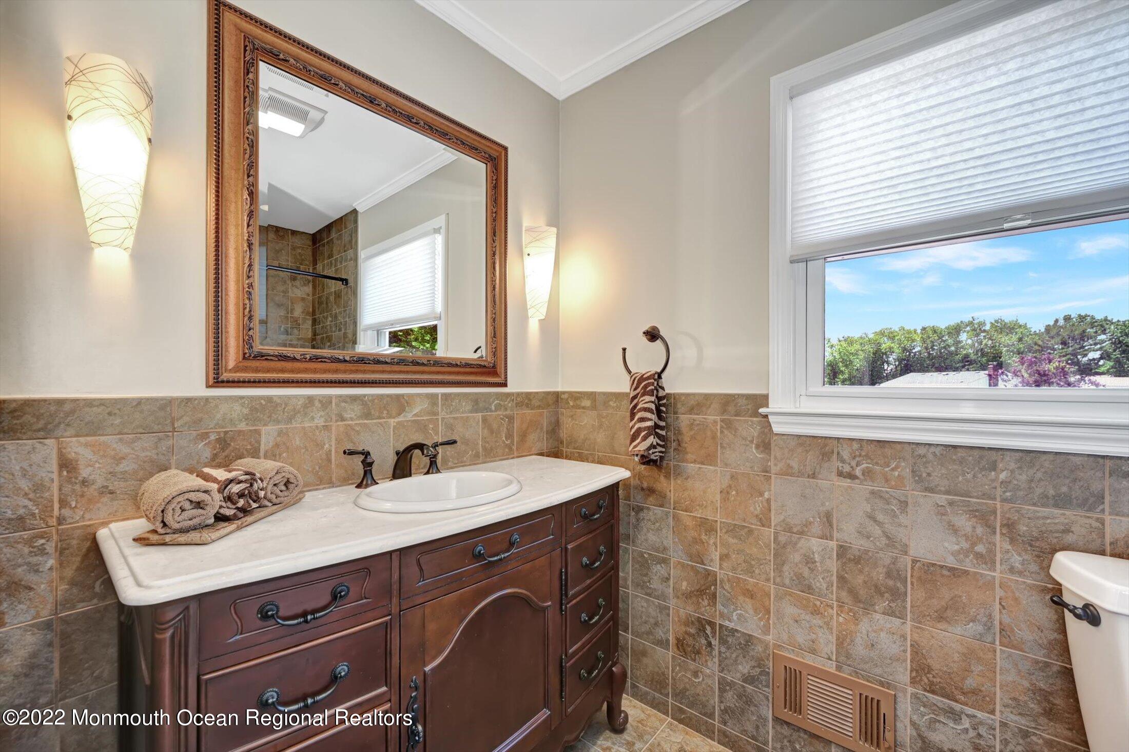 4 Sussex Road Morganville, NJ 07751 - Photo 28 of 55 a bathroom with a sink vanity and a mirror