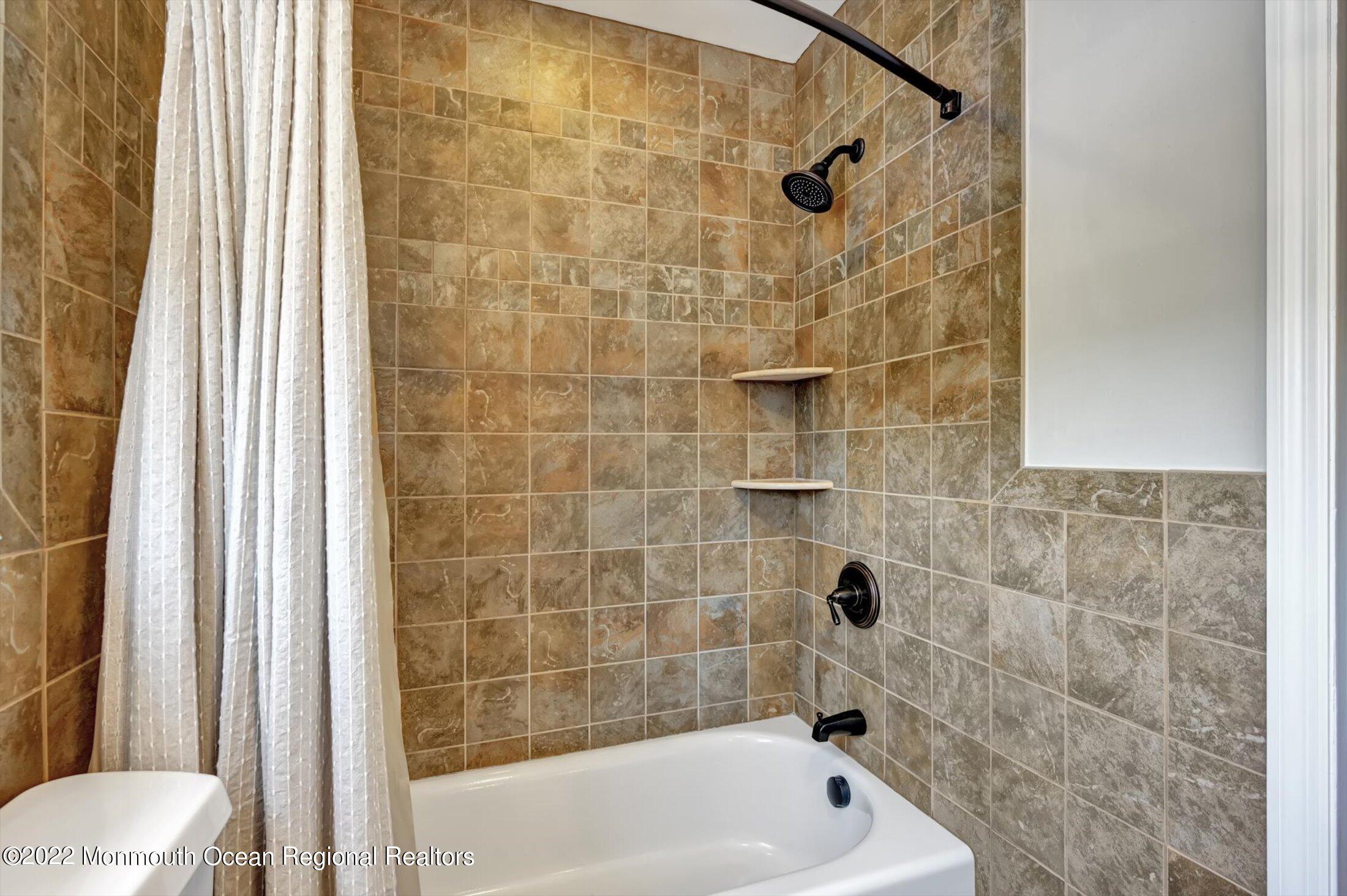4 Sussex Road Morganville, NJ 07751 - Photo 29 of 55 a bathroom with a bathtub and a shower