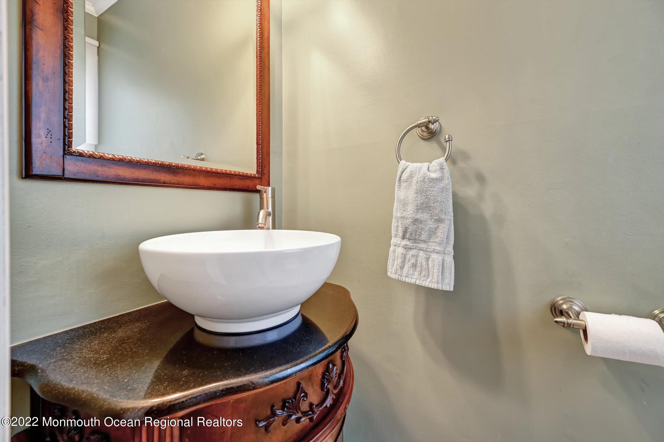 4 Sussex Road Morganville, NJ 07751 - Photo 30 of 55 a bathroom with a toilet sink and mirror