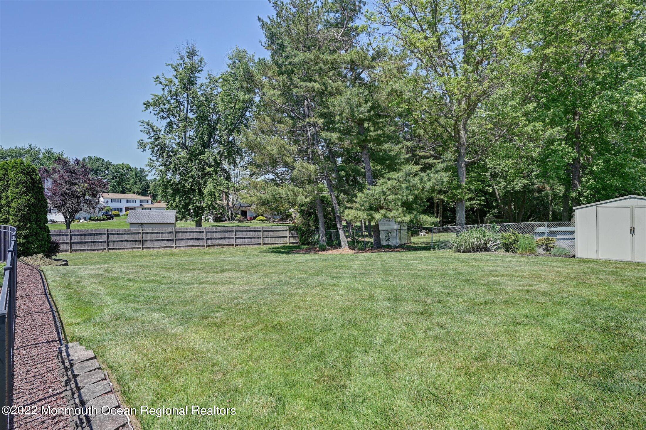 4 Sussex Road Morganville, NJ 07751 - Photo 37 of 55 a backyard of a house with lots of green space