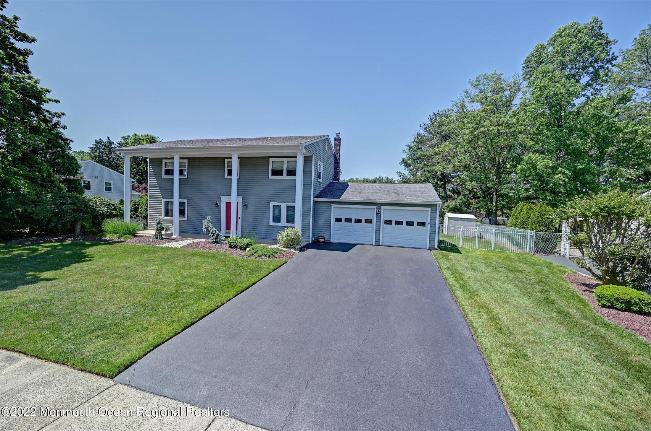 4 Sussex Road Morganville, NJ 07751 - Photo 42 of 55 a front view of house with yard and green space
