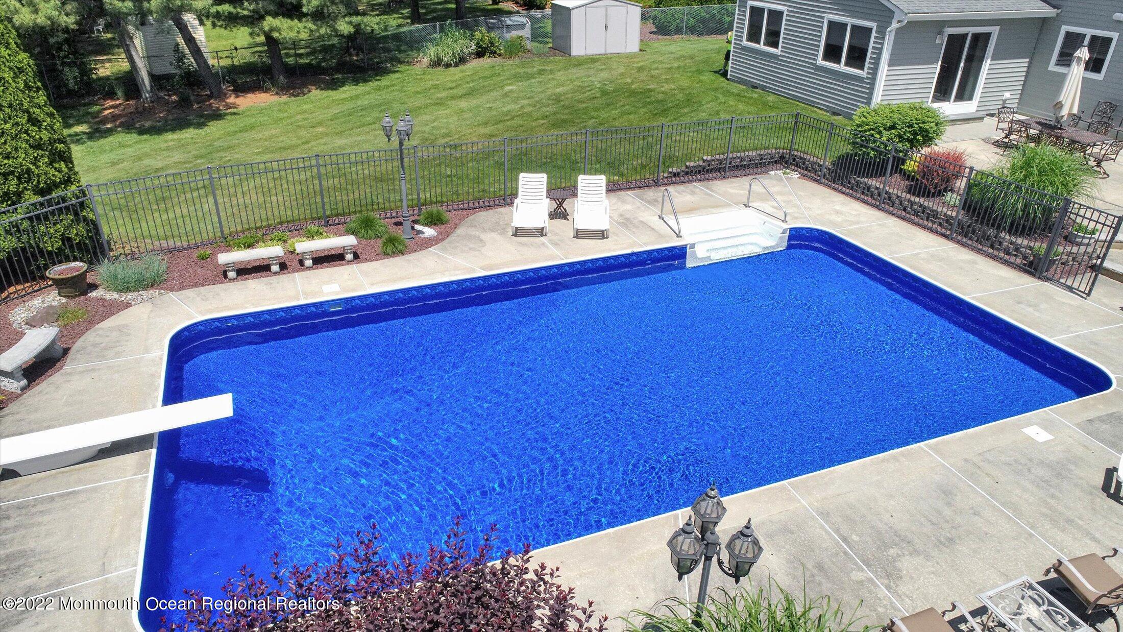 4 Sussex Road Morganville, NJ 07751 - Photo 43 of 55 a view of backyard with swimming pool and outdoor seating