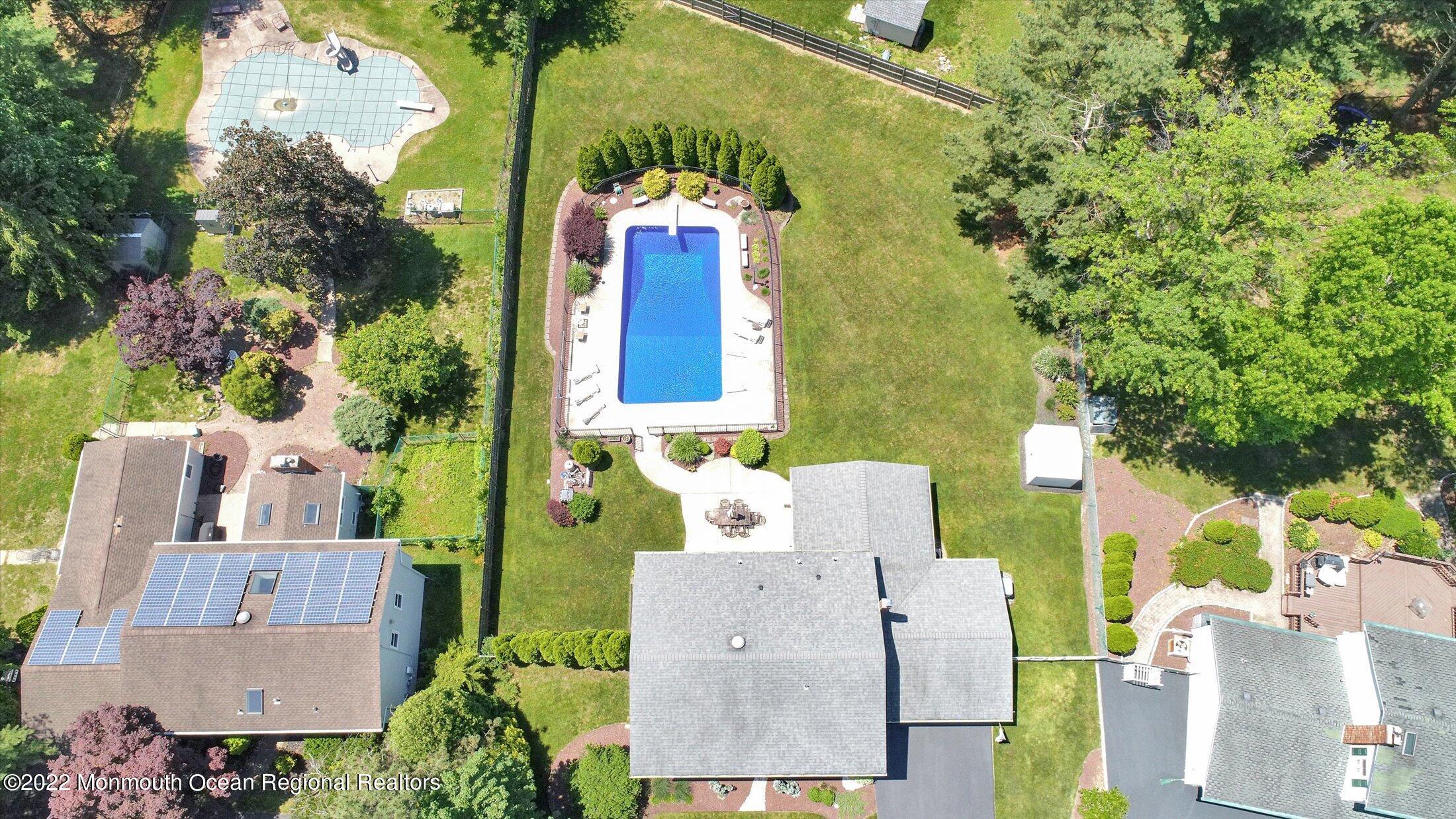 4 Sussex Road Morganville, NJ 07751 - Photo 53 of 55 an aerial view of a house with a yard and pool