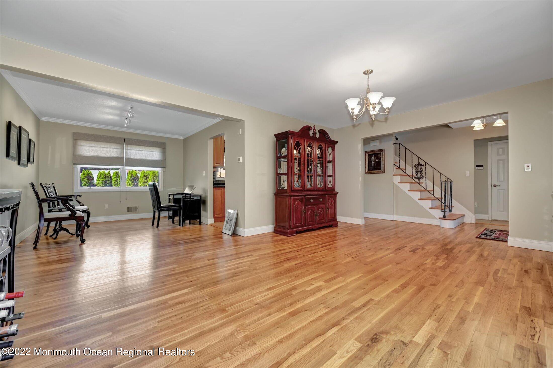 4 Sussex Road Morganville, NJ 07751 - Photo 8 of 55 a view of a livingroom with furniture a dinning room and stairs
