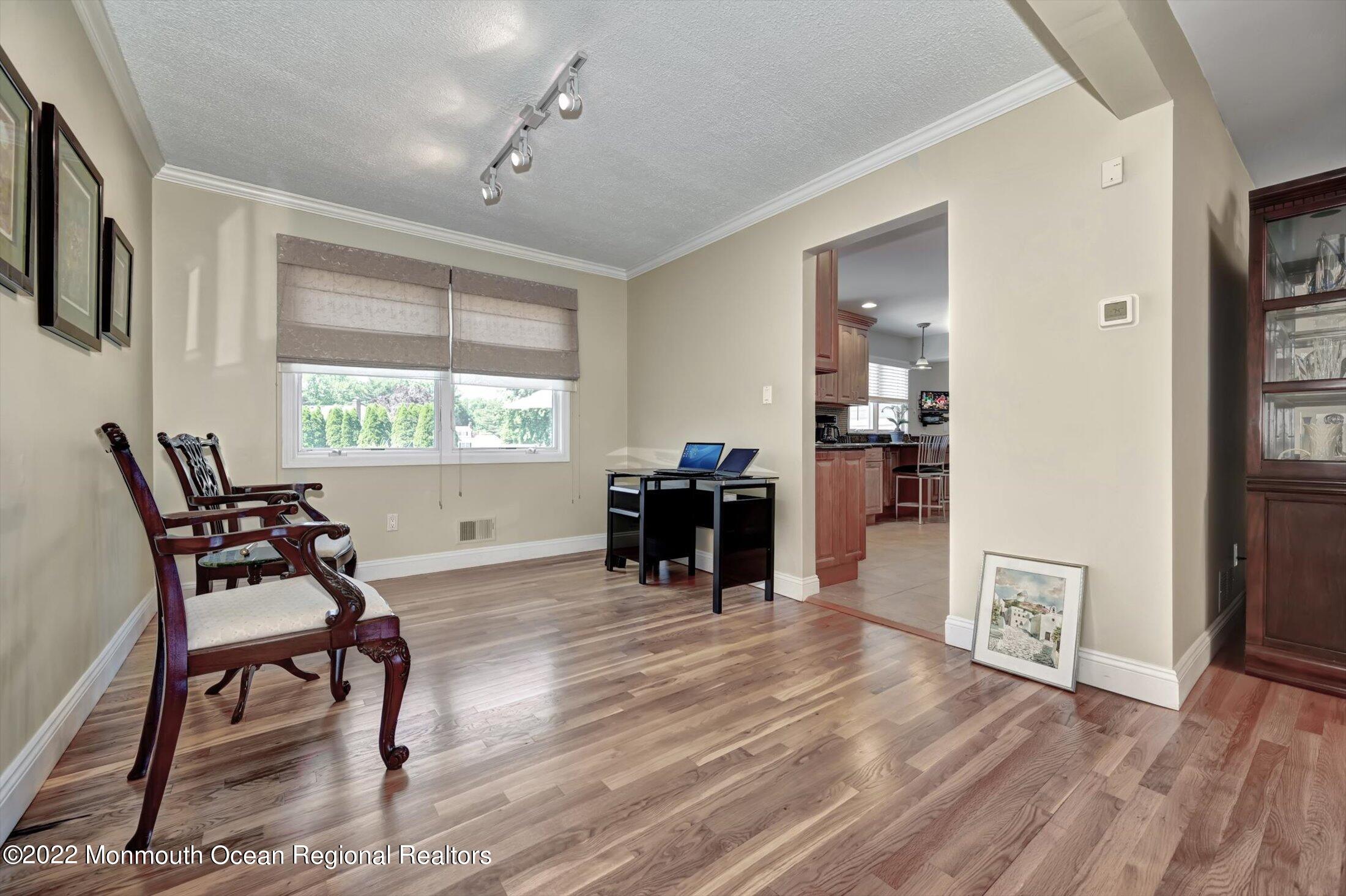 4 Sussex Road Morganville, NJ 07751 - Photo 9 of 55 a living room with furniture and a dining table with kitchen view