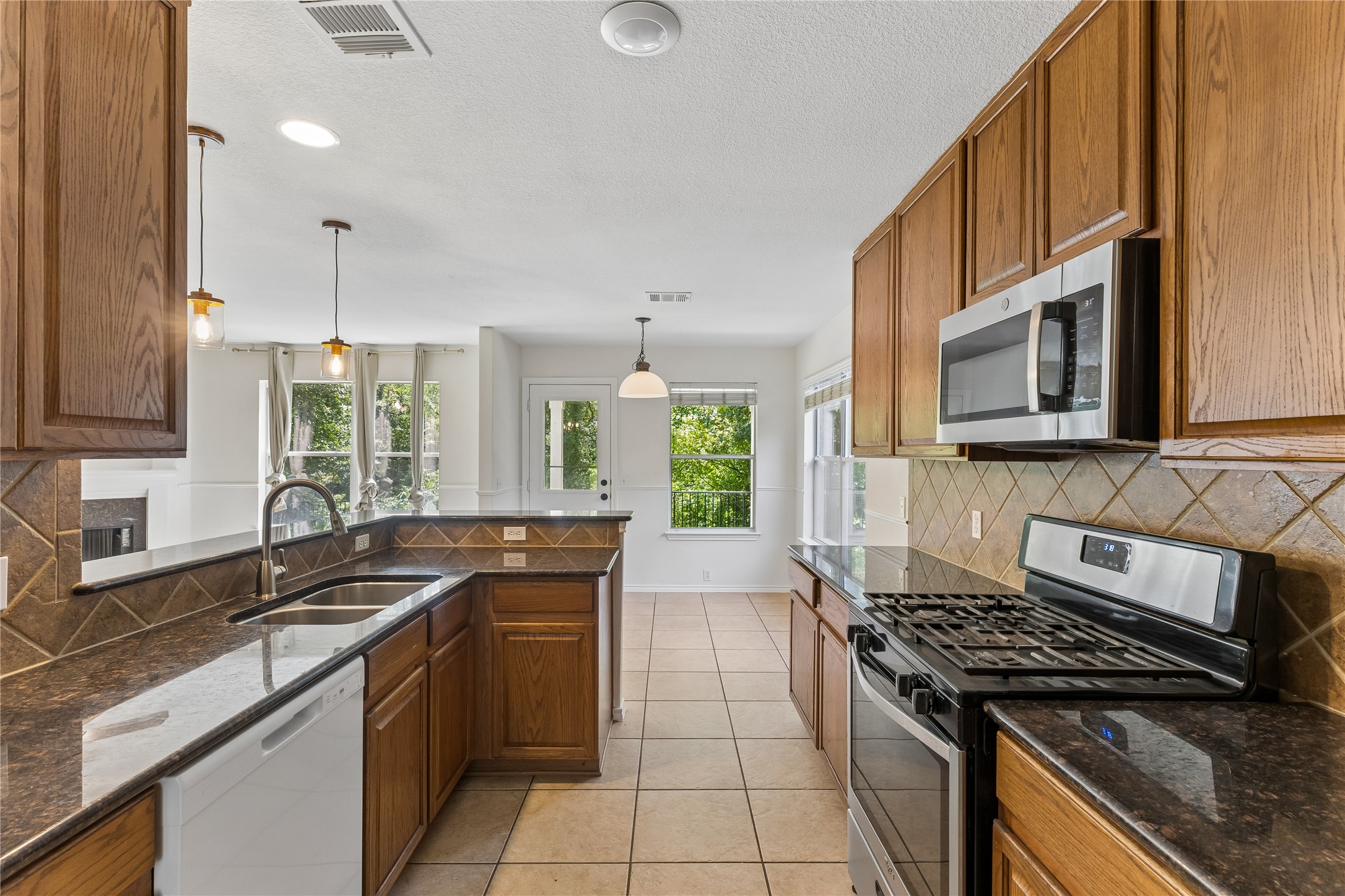 2372 Paradise Ridge Drive Round Rock, TX 78665 - Photo 6 of 40 A well-appointed kitchen features rich wooden cabinetry, gleaming countertops, and modern appliances.