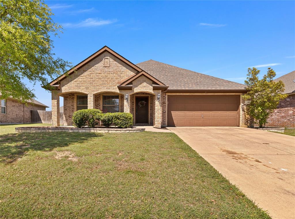 15 Bluebird Lane Sanger, TX 76266 - Photo 1 of 1 Ranch-style home with a front yard, brick siding, driveway, and an attached garage