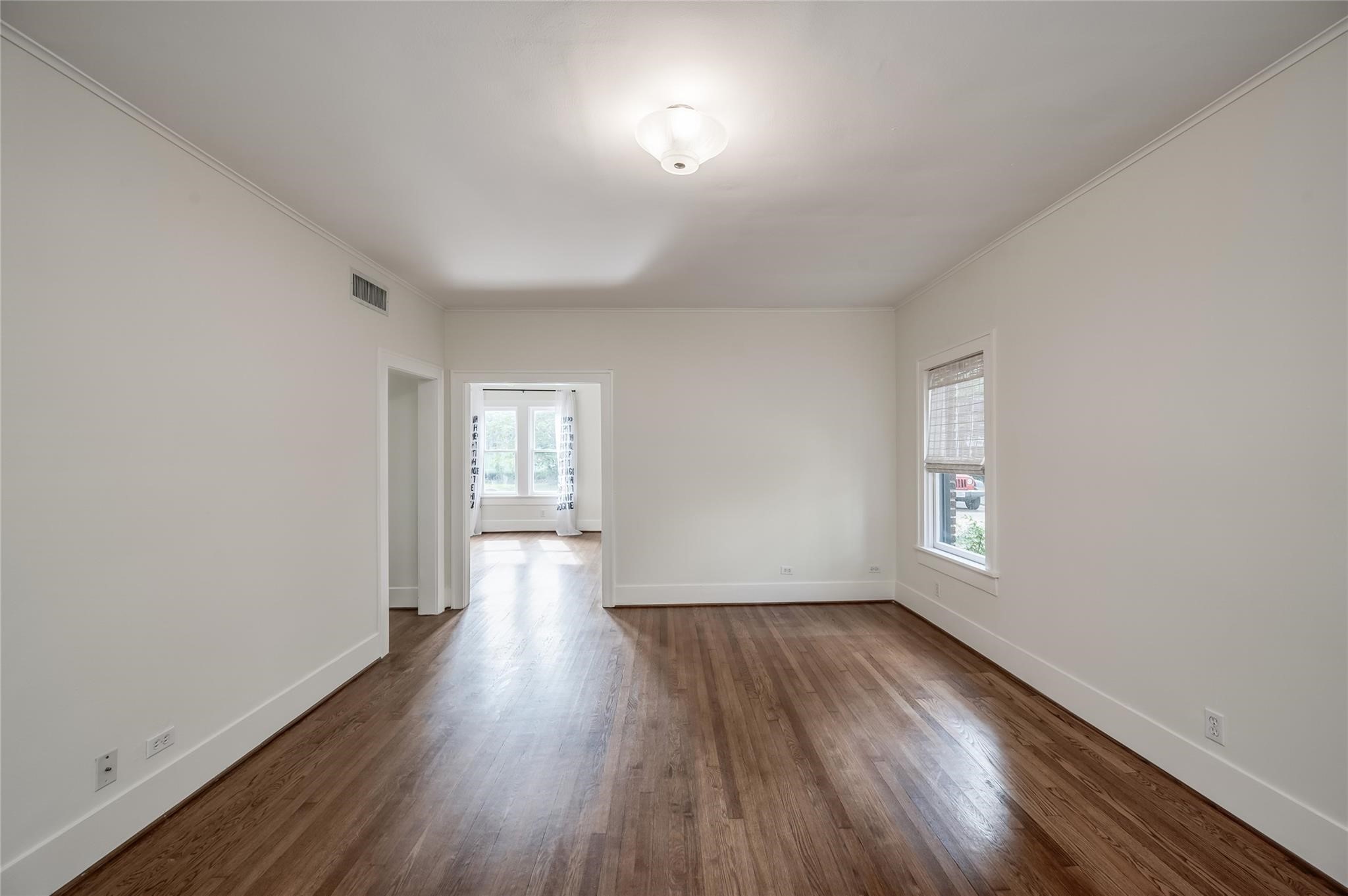 1737 Albans Road, Unit 1 Houston, TX 77005 - Photo 11 of 13 an empty room with wooden floor and windows