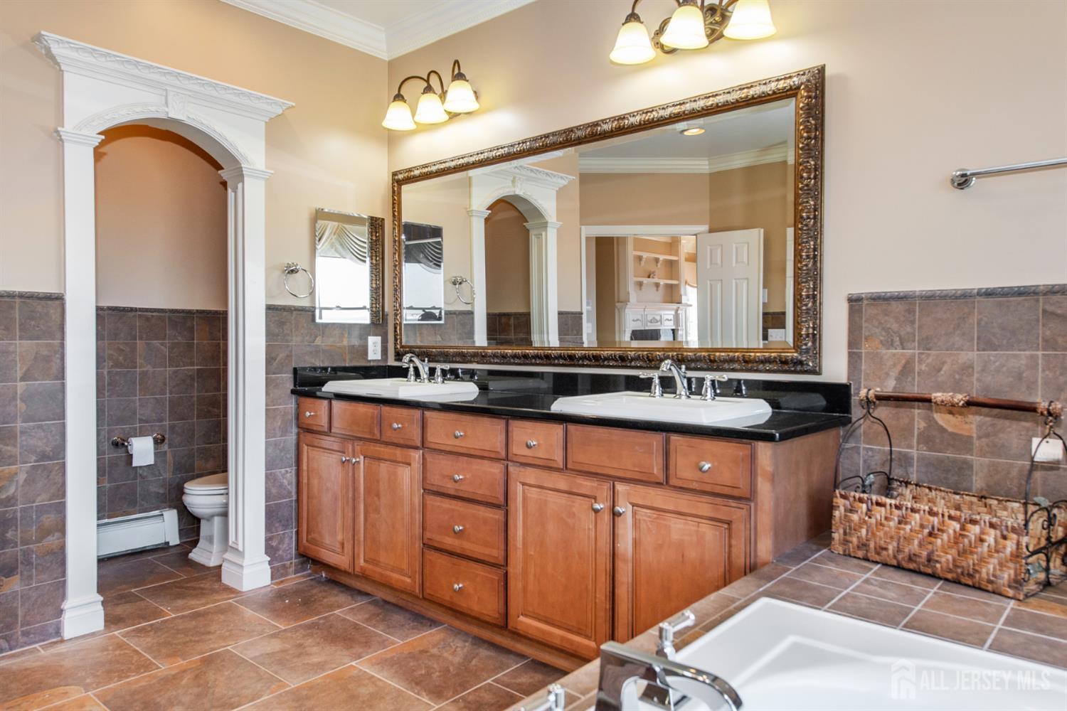 76 Raritan Reach Road South Amboy, NJ 08879 - Photo 18 of 48 a spacious bathroom with a granite countertop sink and a mirror