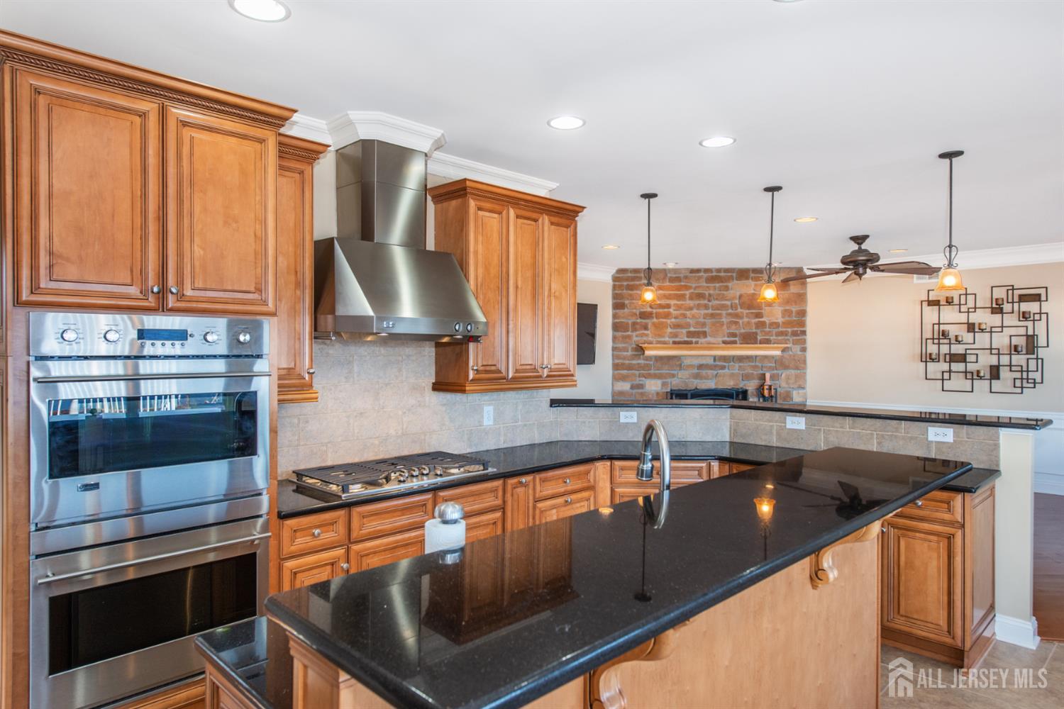 76 Raritan Reach Road South Amboy, NJ 08879 - Photo 22 of 48 a kitchen with kitchen island granite countertop a sink stainless steel appliances and cabinets