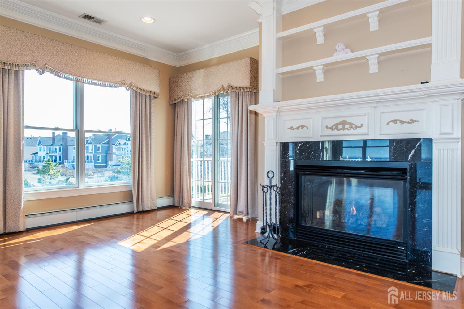 76 Raritan Reach Road South Amboy, NJ 08879 - Photo 27 of 48 a living room with stainless steel appliances wooden floor and a fireplace