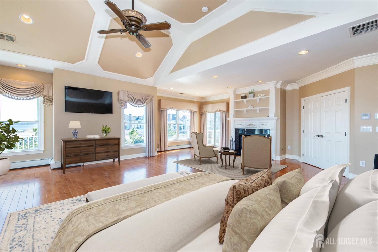 76 Raritan Reach Road South Amboy, NJ 08879 - Photo 30 of 48 a bedroom with a bed a flat screen tv and a large window