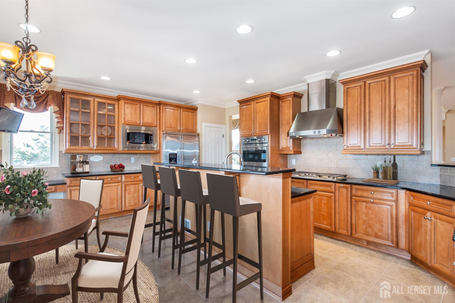 76 Raritan Reach Road South Amboy, NJ 08879 - Photo 32 of 48 a kitchen with stainless steel appliances granite countertop table chairs sink and cabinets