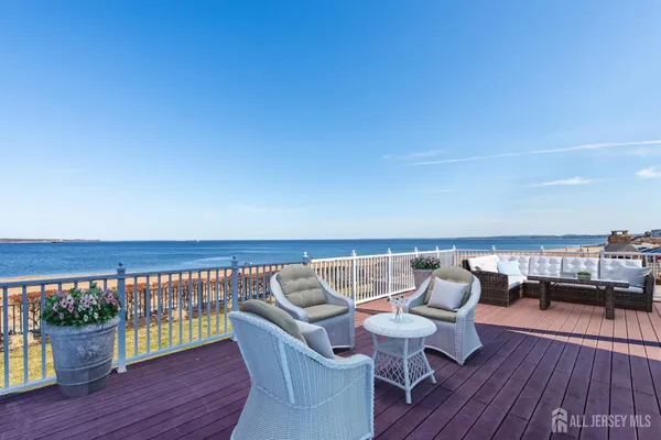 a roof deck with a table and chairs