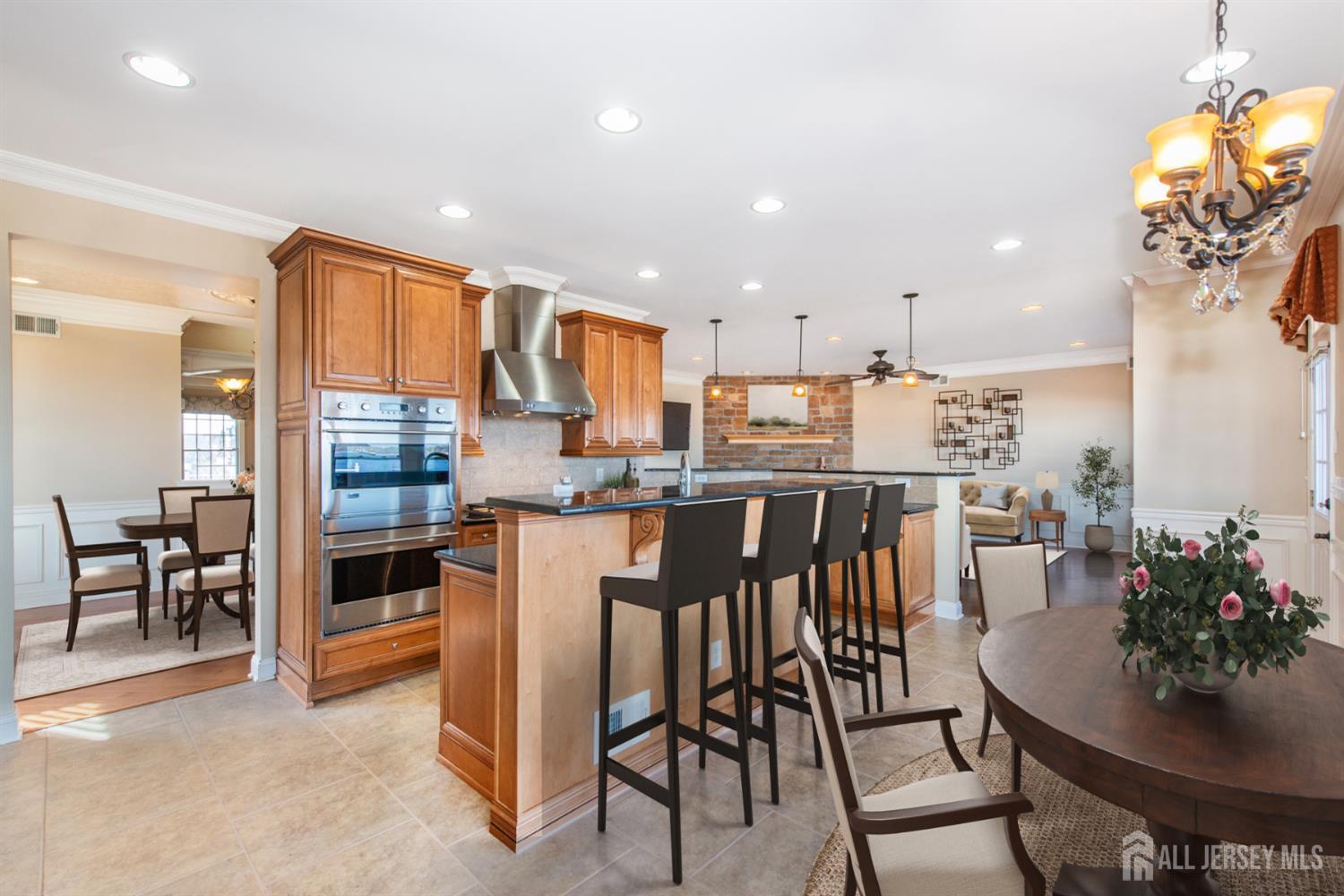 76 Raritan Reach Road South Amboy, NJ 08879 - Photo 48 of 48 a kitchen with stainless steel appliances kitchen island granite countertop a table and chairs in it