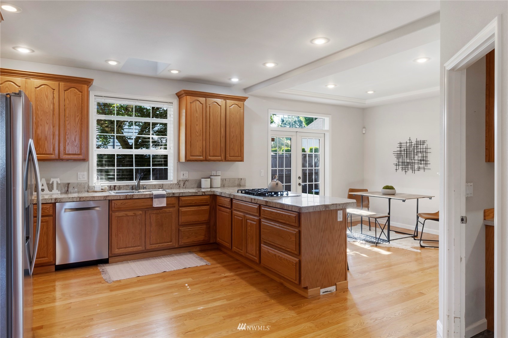 3904 Park Avenue North Renton, WA 98056 - Photo 12 of 40 a kitchen with stainless steel appliances granite countertop sink stove and refrigerator