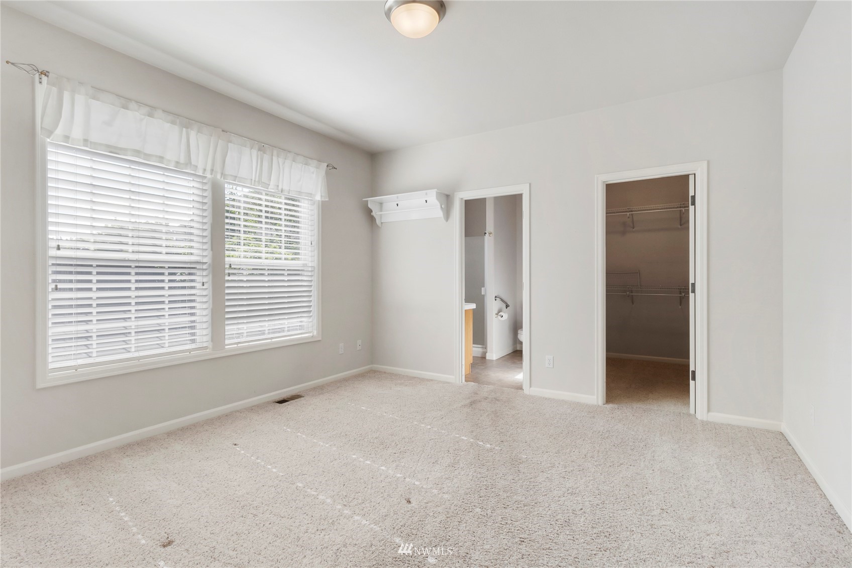3904 Park Avenue North Renton, WA 98056 - Photo 21 of 40 a view of an empty room with a window and a kitchen