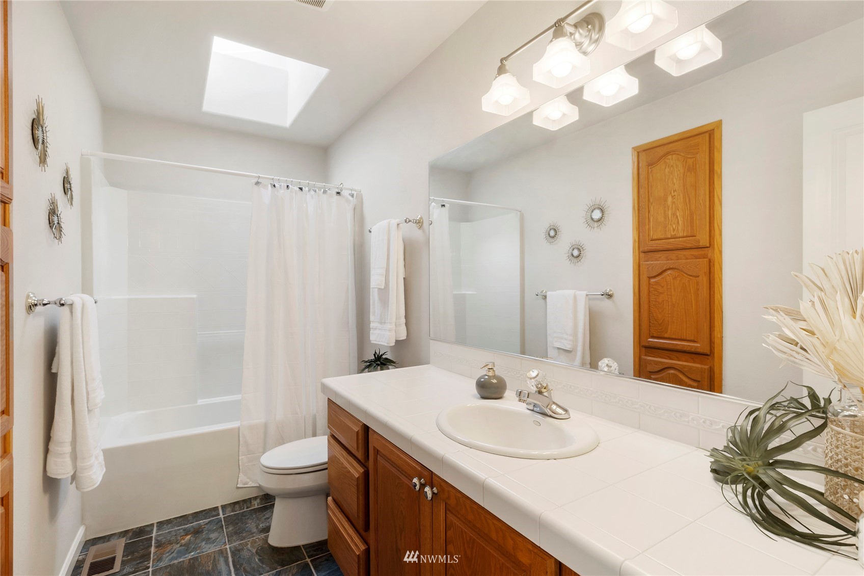 3904 Park Avenue North Renton, WA 98056 - Photo 35 of 40 a bathroom with a granite countertop sink toilet and shower