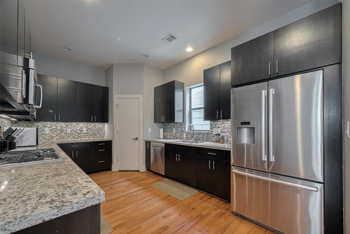 2115 Hadley Street Houston, TX 77003 - Photo 13 of 34 a kitchen with stainless steel appliances granite countertop a refrigerator stove and sink