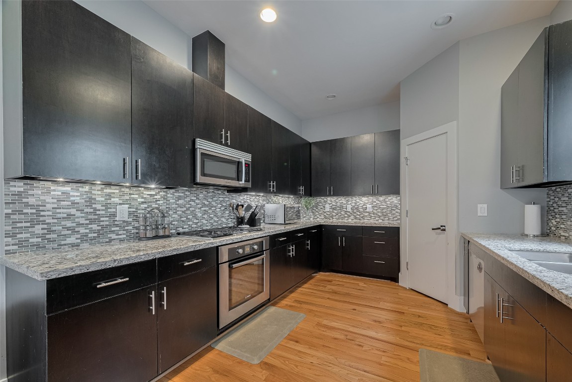 2115 Hadley Street Houston, TX 77003 - Photo 14 of 34 a large kitchen with granite countertop a sink and stove top oven