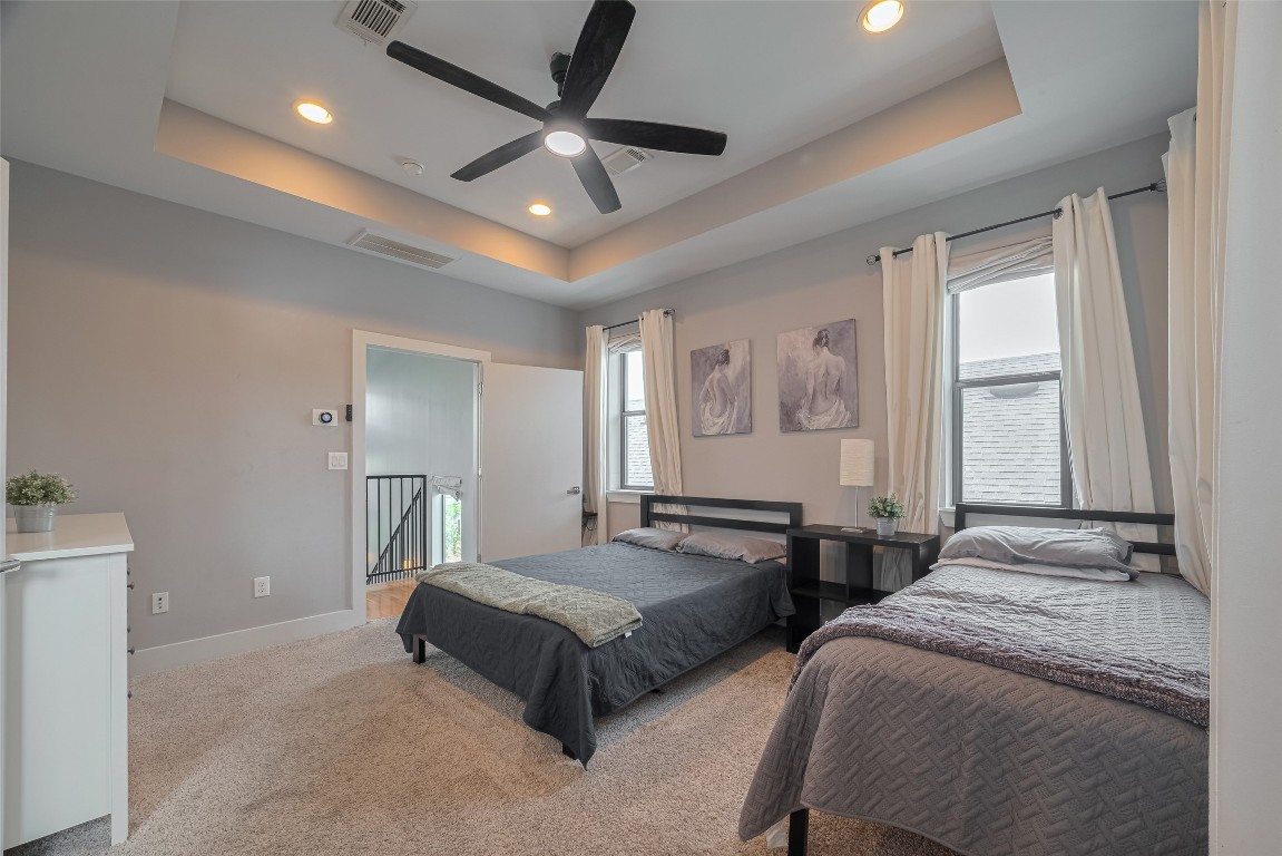 2115 Hadley Street Houston, TX 77003 - Photo 18 of 34 a spacious bedroom with two beds and a chandelier