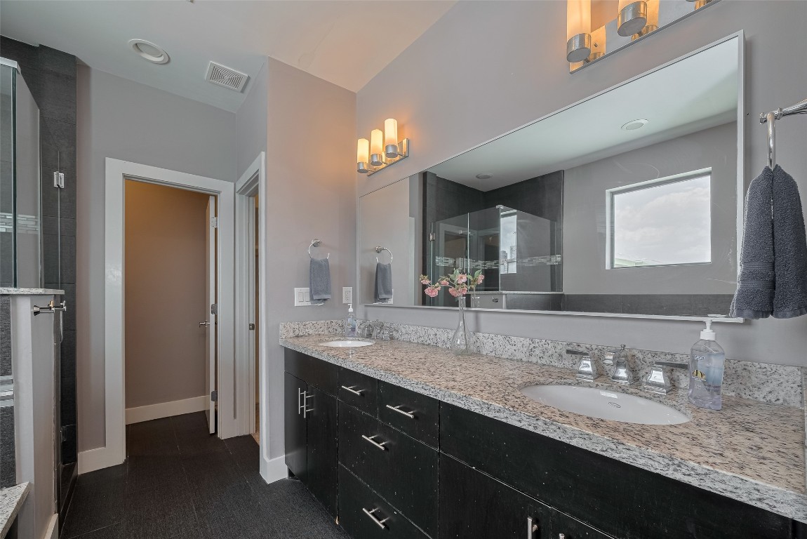 2115 Hadley Street Houston, TX 77003 - Photo 21 of 34 a bathroom with a granite countertop sink double and mirror