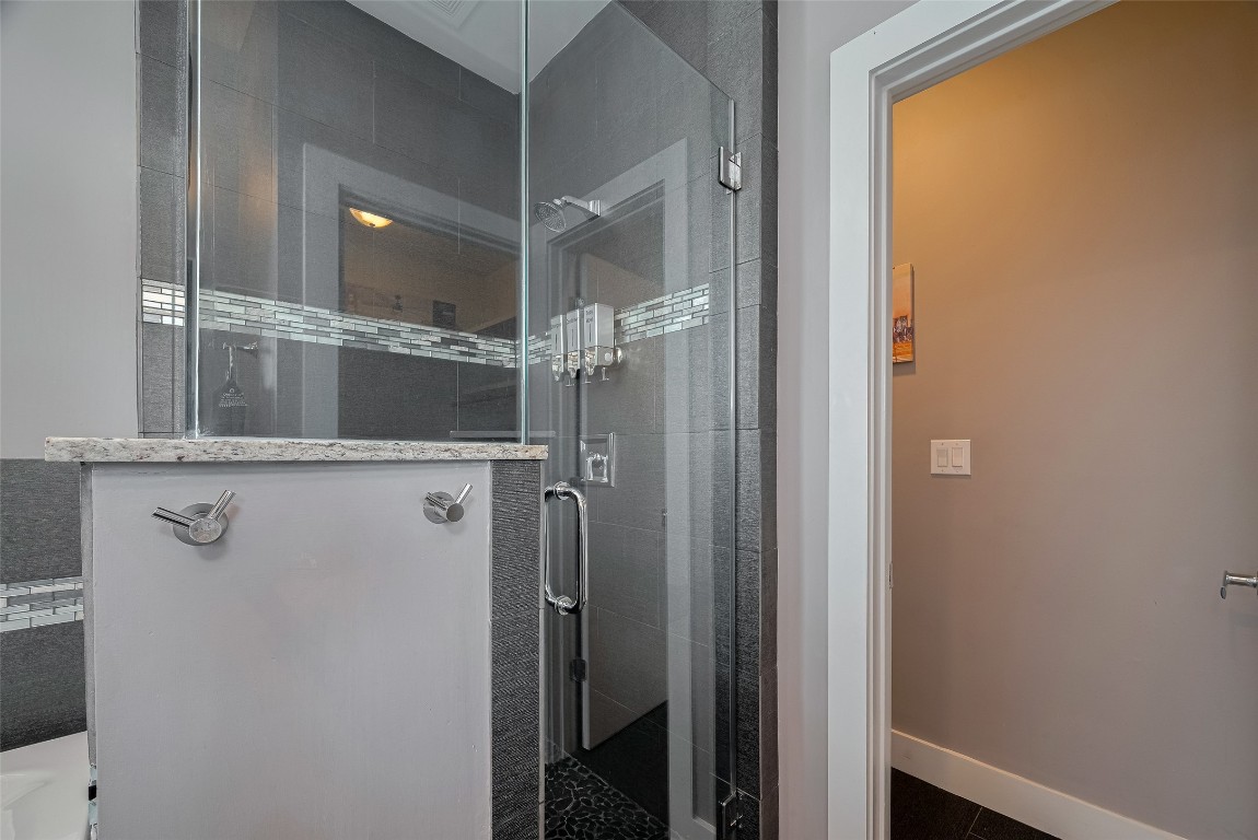 2115 Hadley Street Houston, TX 77003 - Photo 22 of 34 a bathroom with a glass shower door