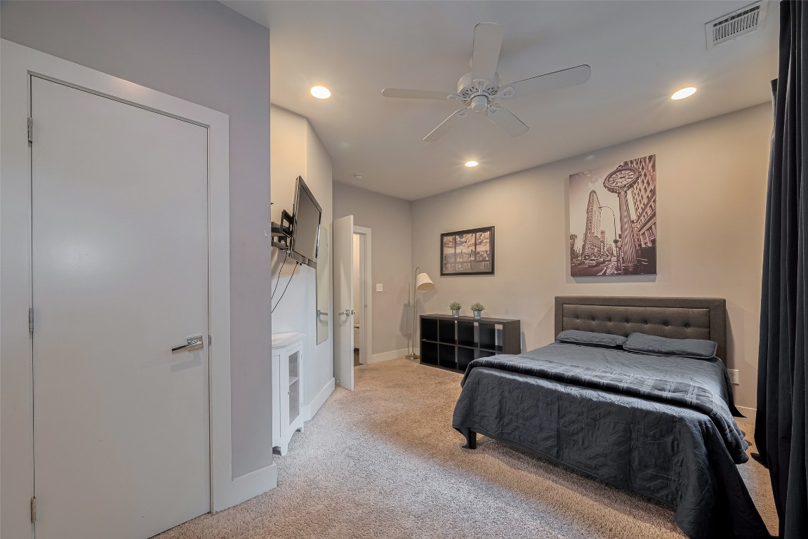 2115 Hadley Street Houston, TX 77003 - Photo 25 of 34 a spacious bedroom with a bed and ceiling fan
