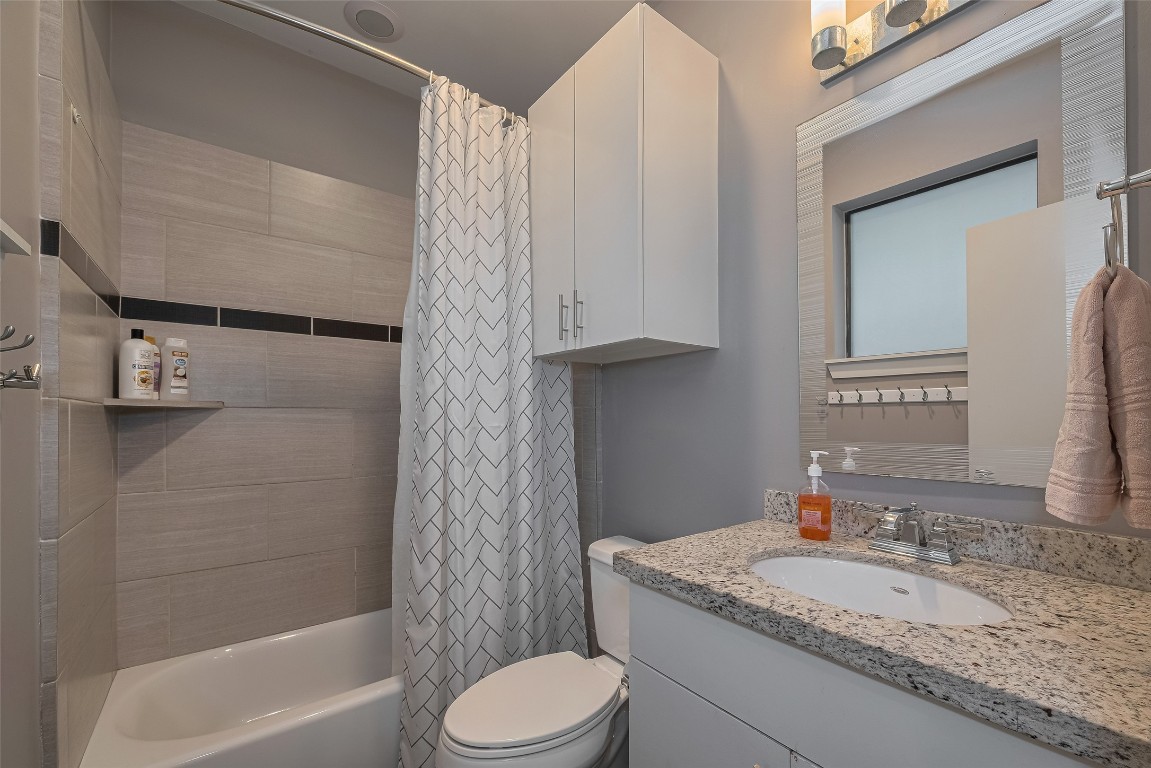 2115 Hadley Street Houston, TX 77003 - Photo 29 of 34 a bathroom with a granite countertop sink toilet and shower