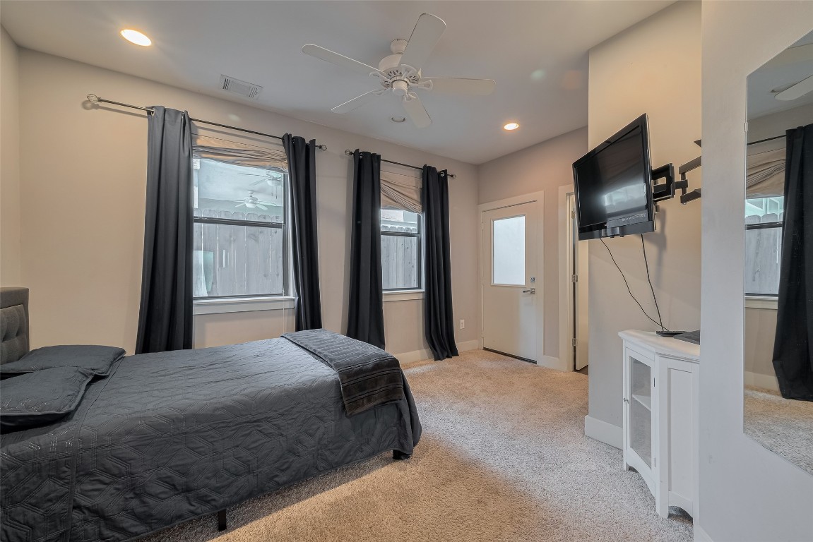 2115 Hadley Street Houston, TX 77003 - Photo 30 of 34 a spacious bedroom with a large bed and a flat screen tv