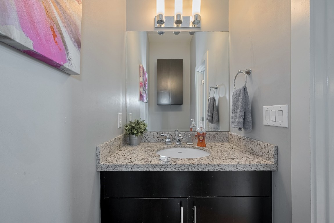 2115 Hadley Street Houston, TX 77003 - Photo 31 of 34 a bathroom with a granite countertop sink and a mirror