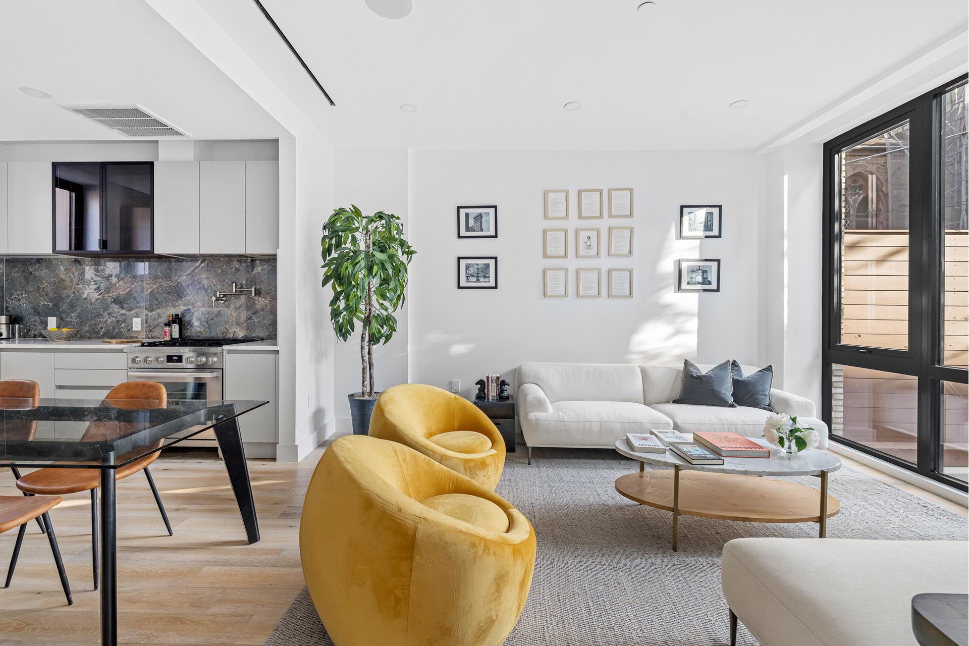 a living room with furniture and a potted plant
