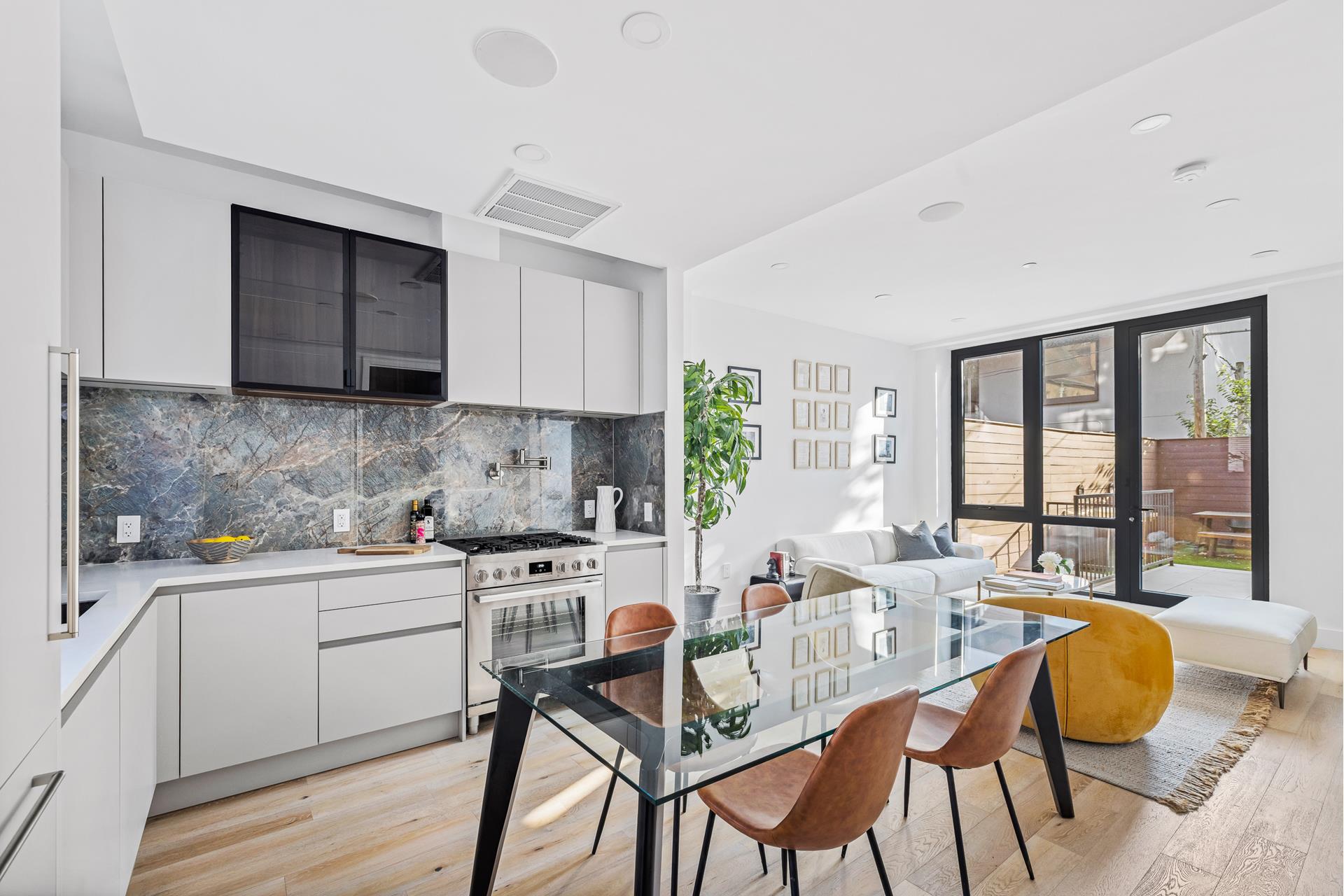 218 Classon Avenue, Unit GARDEN Brooklyn, NY 11205 - Photo 3 of 18 a kitchen with stainless steel appliances a stove a sink cabinets and a dining table
