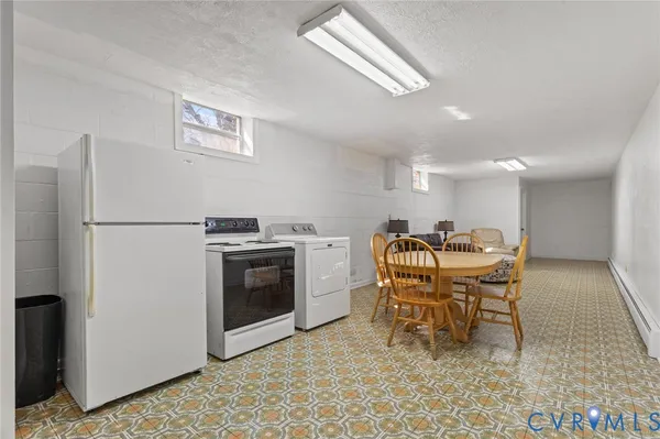 a kitchen with a table chairs and a refrigerator