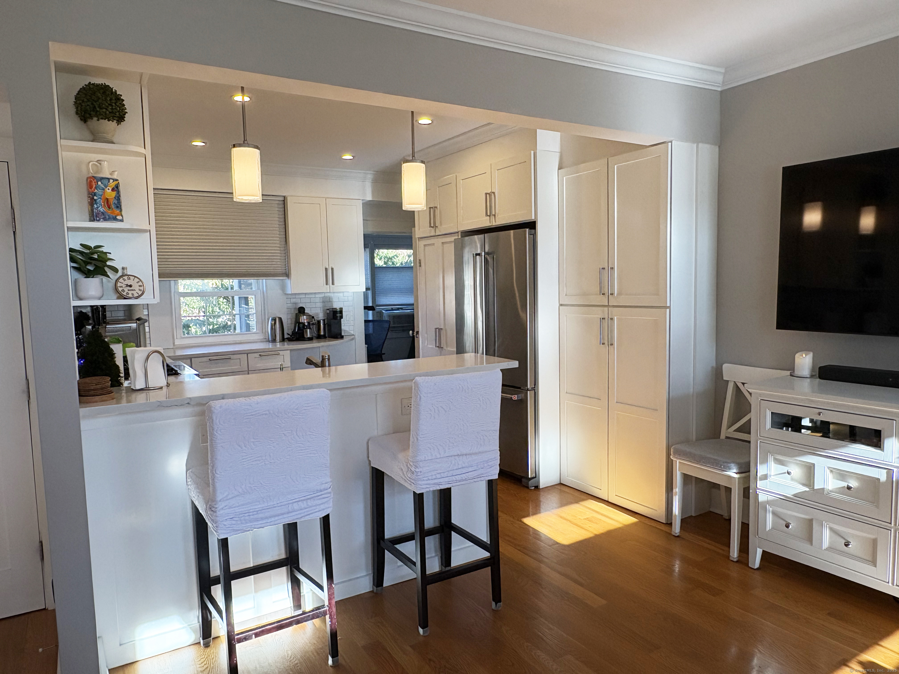 20 Haddon Street, Unit 5 Bridgeport, CT 06605 - Photo 7 of 40 a kitchen with stainless steel appliances granite countertop a stove a refrigerator a sink a dining table and chairs with wooden floor