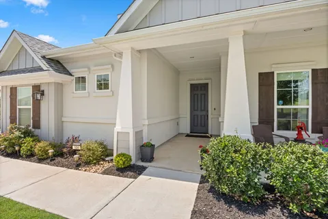 a front view of a house with garden