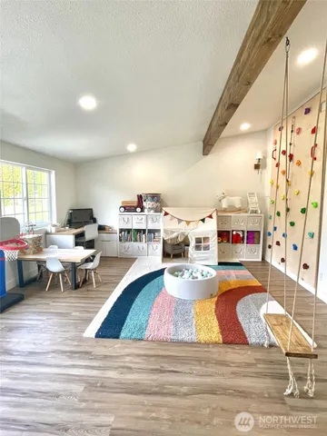 a living room with lots of furniture and a wooden floor