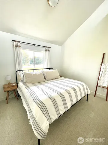 a bedroom with a bed and window